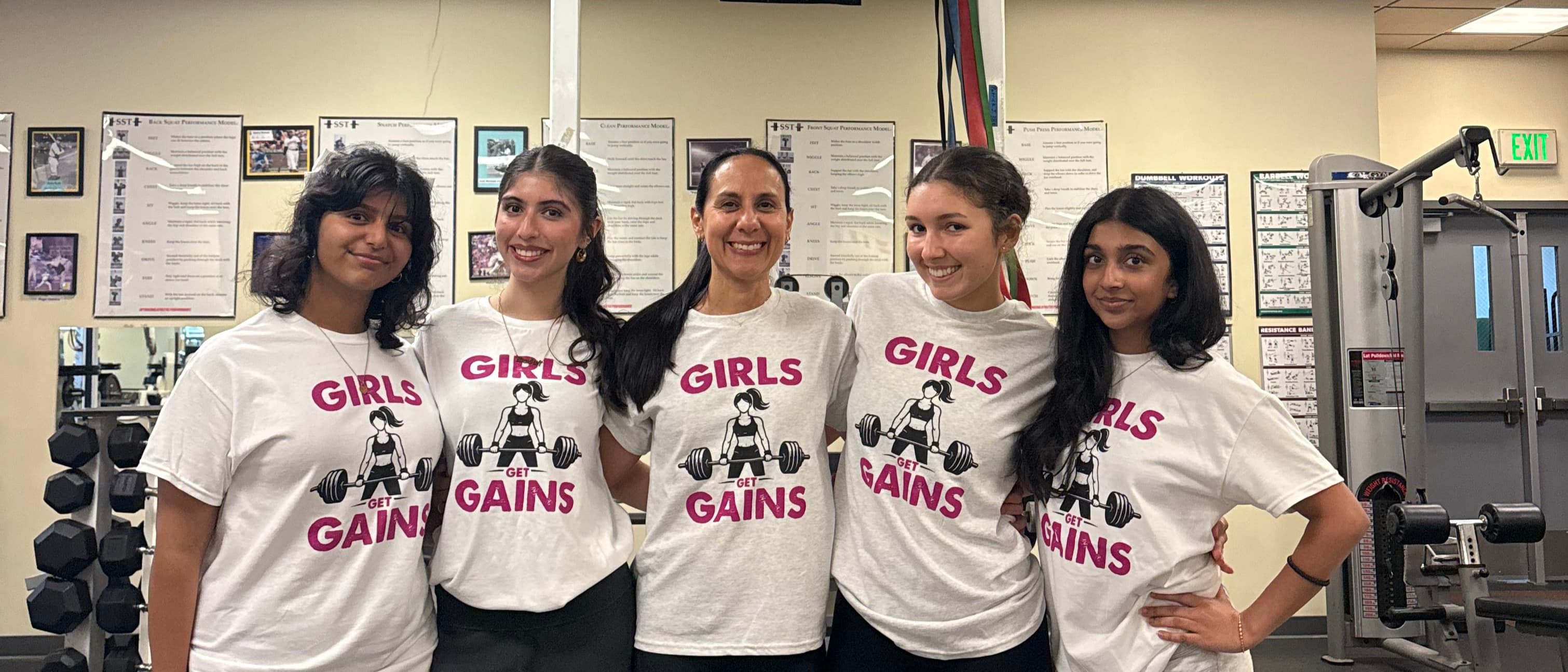 The Girls Get Gains team in club shirts with Dr. Rogers in the middle
